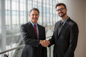 two men shake hands