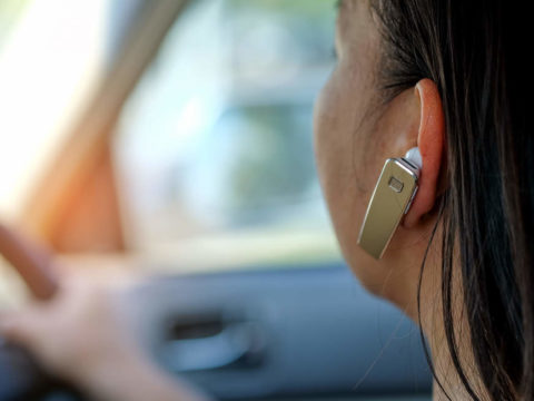 MPs have said hands-free mobiles should be banned whilst driving.
