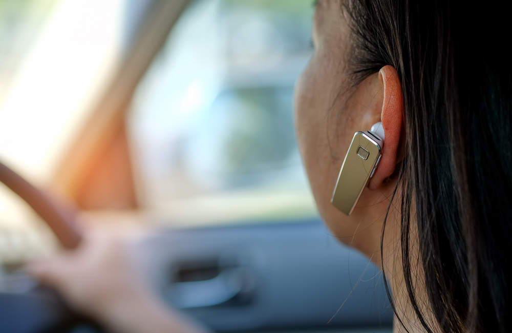 MPs have said hands-free mobiles should be banned whilst driving.
